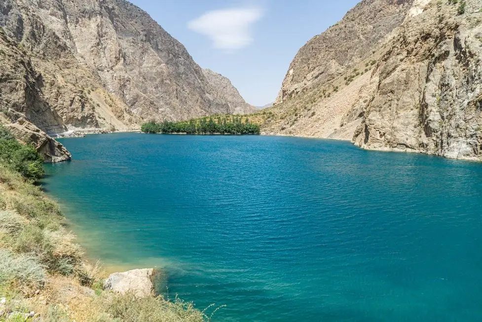 Turquoise mountain lake framed by high cliffs in Tajikistan