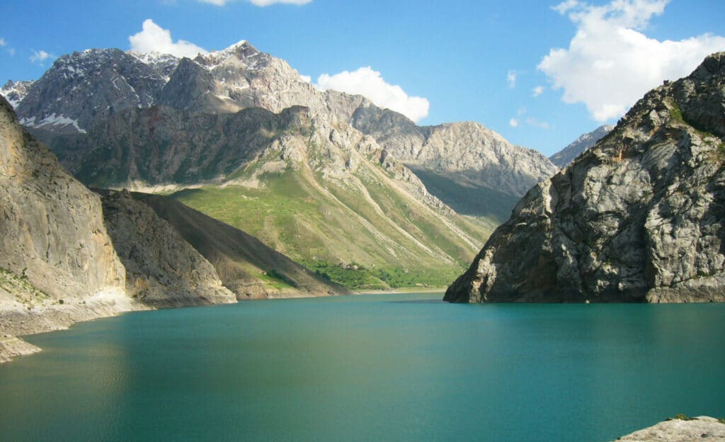 Crystal-clear waters reflecting the mountains at Nofin Lake, Tajikistan